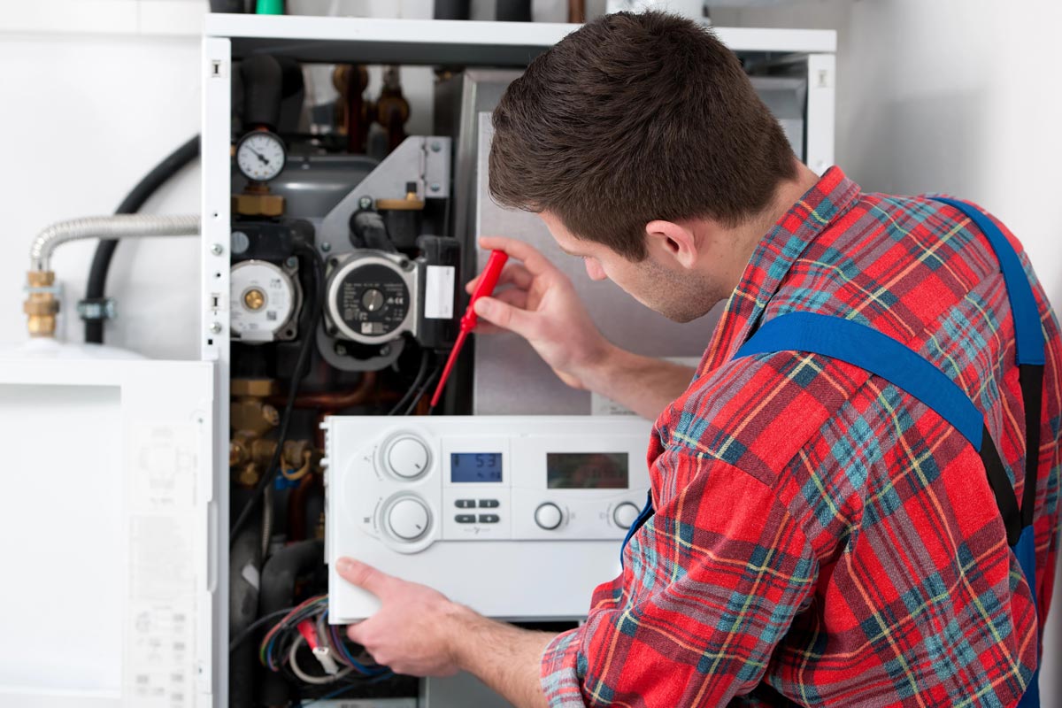 Domestic Electrical Services - Man working on a domestic boiler.